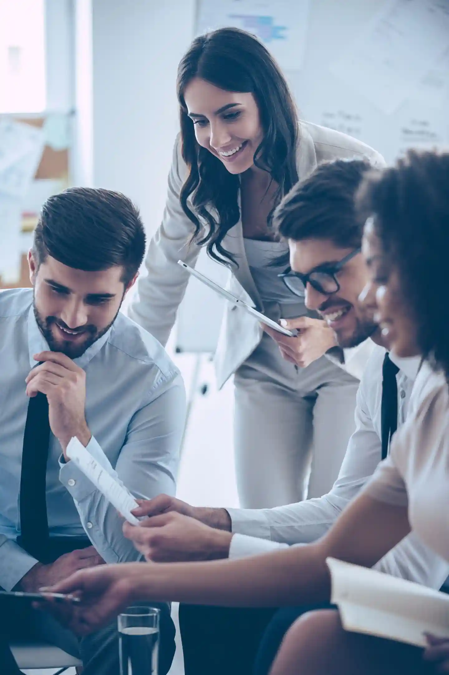 Group of people discussing a report on a paper.